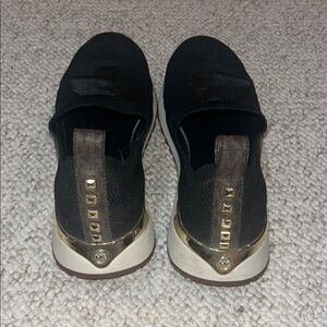 Michael Kors Black Slip-On Sneakers with Gold Trim and Studs